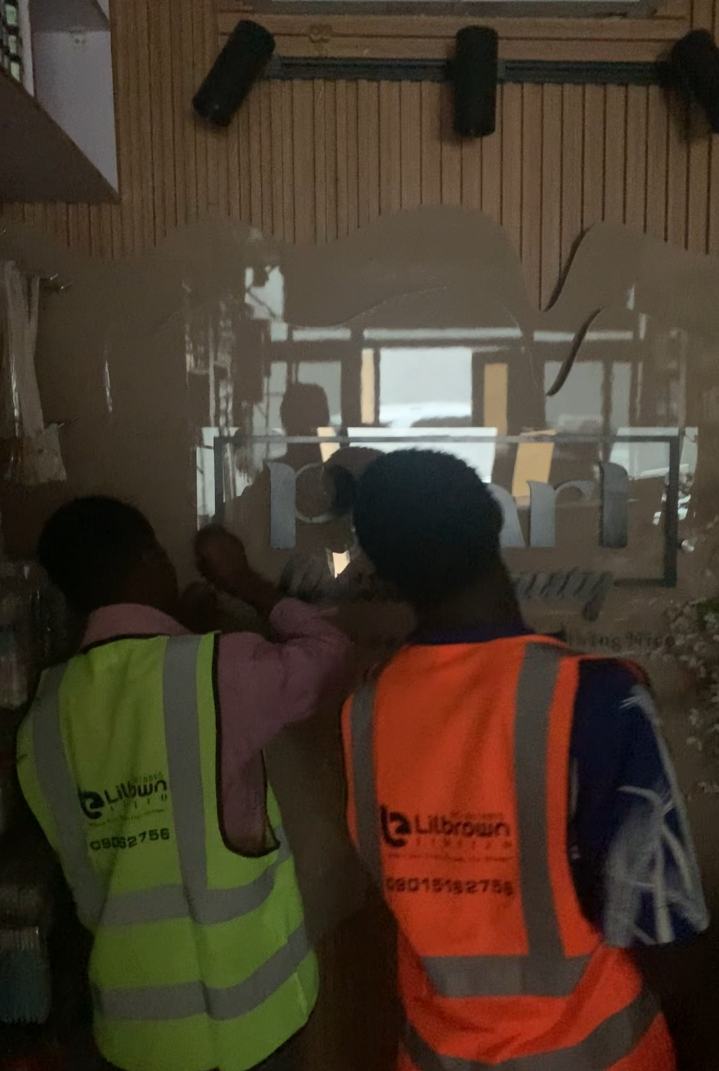 Lilbrown team members installing signage