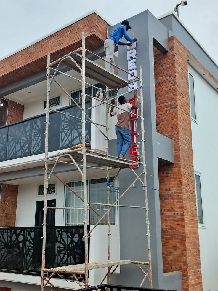 Installation of 3D vertical lettering on a building