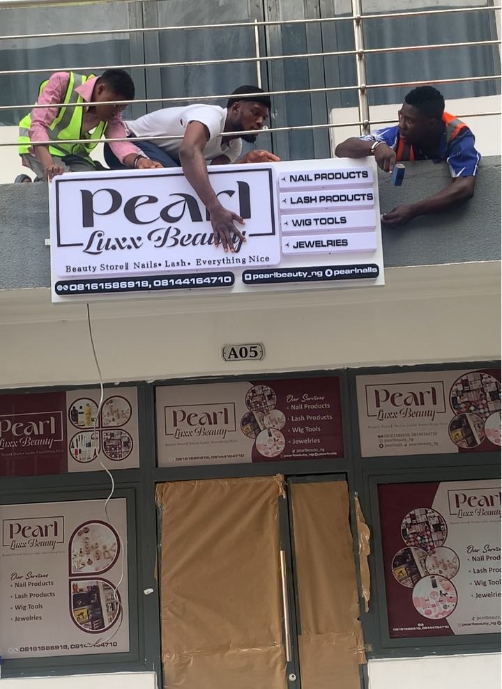Pearl Luxx Beauty shop sign being mounted