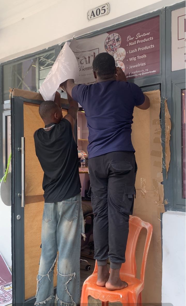 Window graphics being applied for Pearl Luxx Beauty
